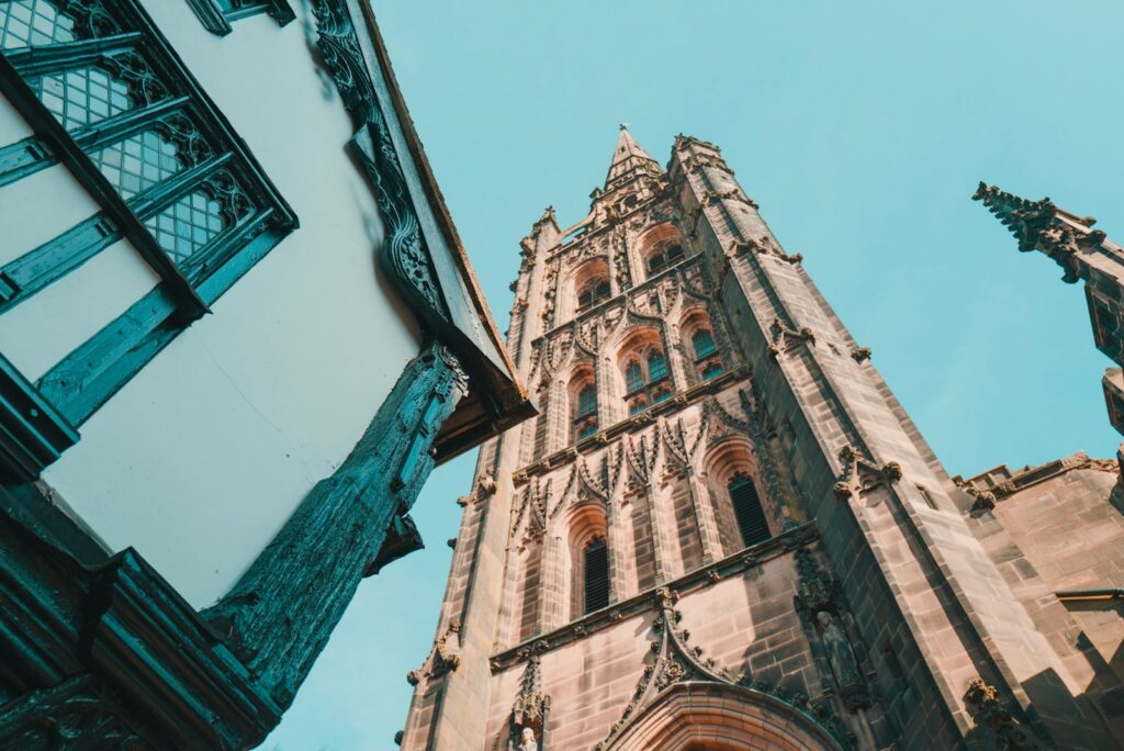Historic buildings and the old cathedral tower in Coventry.