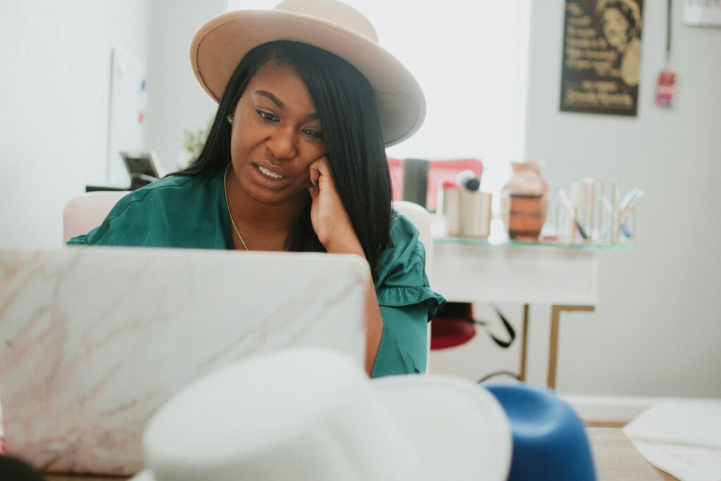 A woman using a laptop at a desk.